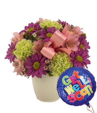 Pink alstroemeria and purple daisies in mug with get well balloon