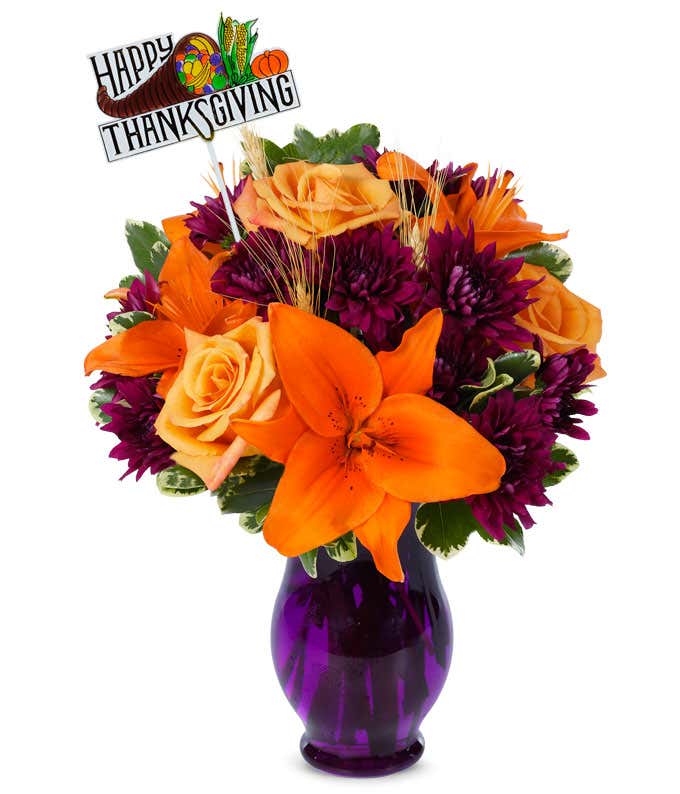 Orange roses & lilies delivery in a purple vase