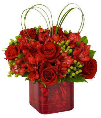 Red roses and alstroemeria in a red vase