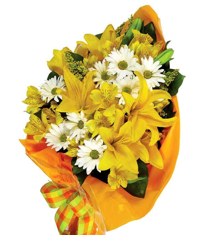 Yellow lilies and white daisies wrapped in floral paper with ribbon