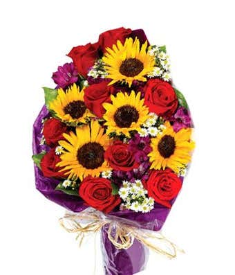 Sunflowers, red roses and purple alstroemeria in hand tied bouquet