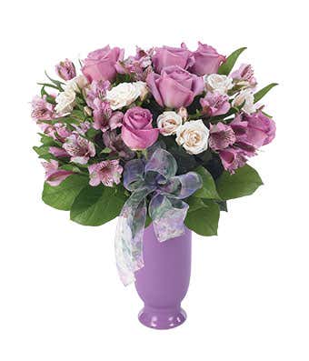 Purple roses, purple alstroemeria and ivory spray roses in purple vase