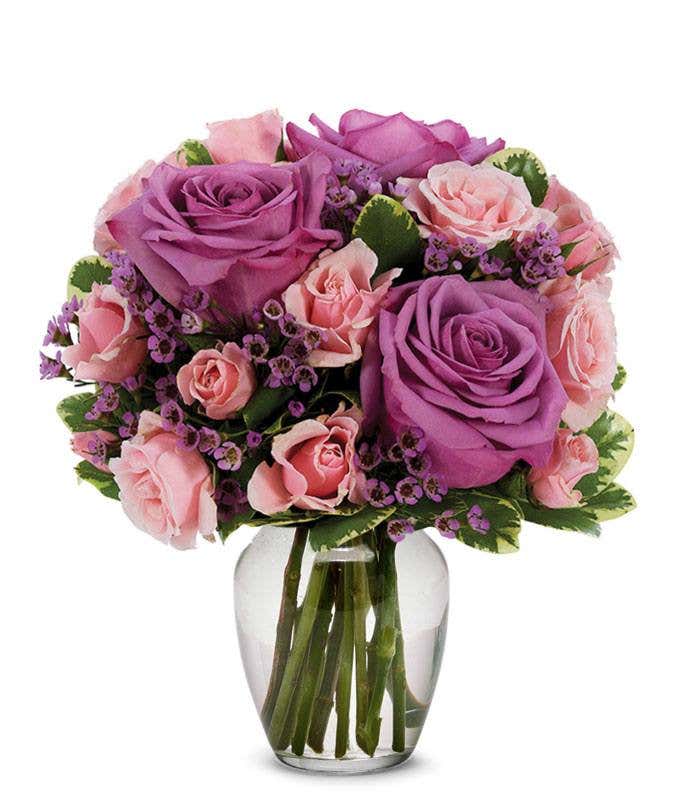 Purple roses paired with pink spray roses