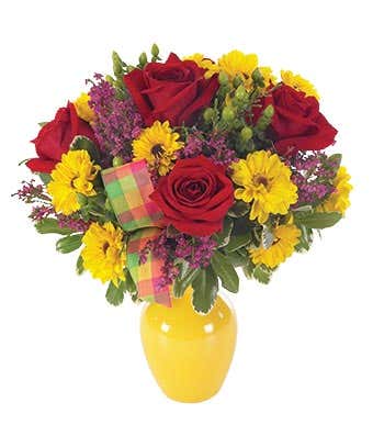 Red roses, yellow daisies and greens in yellow vase