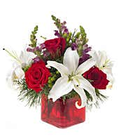 Modern holiday bouquet with roses in a square vase