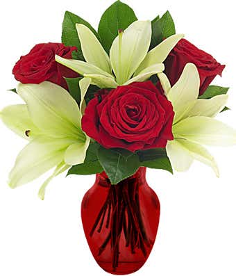 Red roses and white lilies in a red vase