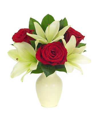 Red roses and white lilies in a white vase