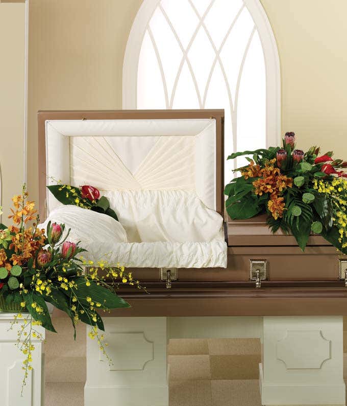 Half casket spray of red, yellow, orange & green orchids