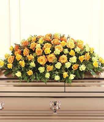 Orange roses, yellow roses and green roses in sympathy casket spray