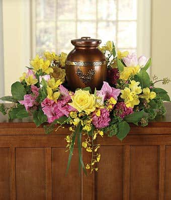 Pink carnations and yellow rose urn floral bouquet