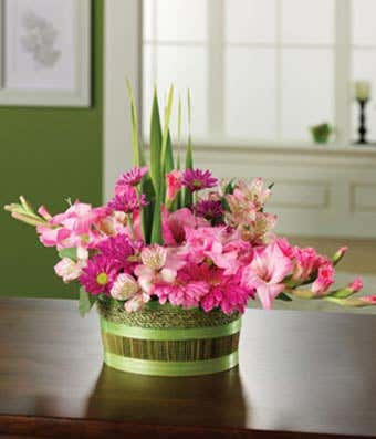 Flower basket with pink gerbera daisies, pink alstroemeria and gladiolus