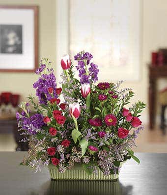 Hot pink spray roses, white tulips and pink asters in a basket