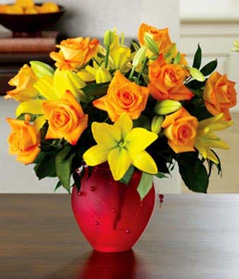 One dozen orange roses and yellow lilies