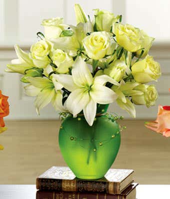 White roses and white lilies in green vase
