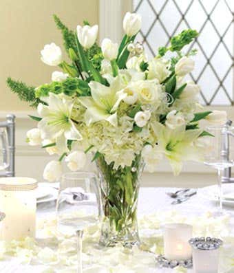 White lilies, tulips, roses and hydrangea in a centerpiece