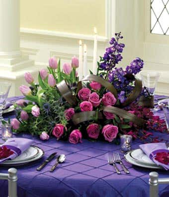 Purple roses and purple tulip in floral centerpiece