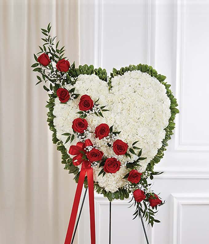White flowers with red rose break in a heart standing spray