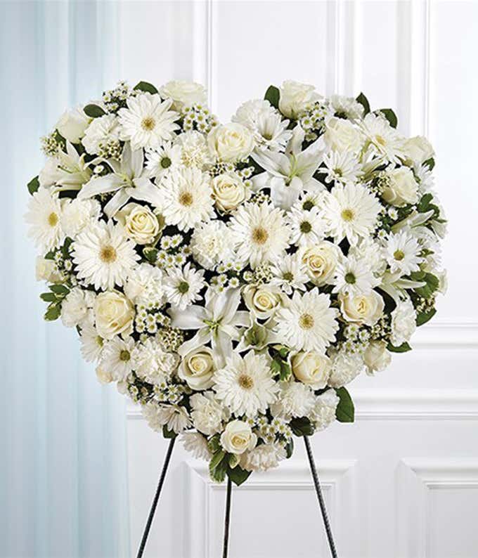 White roses, white lilies and white daisies in heart standing spray