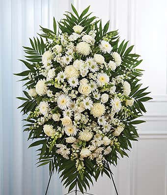 Standing spray with white roses, football mums and snapdragons