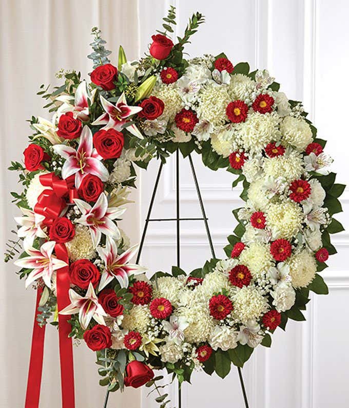 Roses and mums arranged by a florist in a sympathy wreath