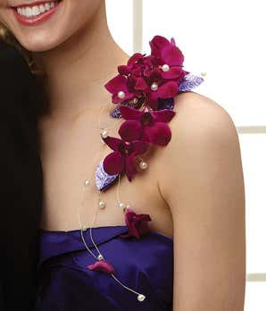 Purple orchid corsage that sits on the shoulder