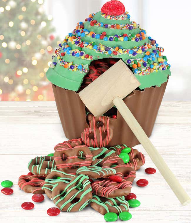 Hollow Belgian chocolate cupcake decorated like a Christmas tree, filled with M&amp;M's and chocolate covered pretzels