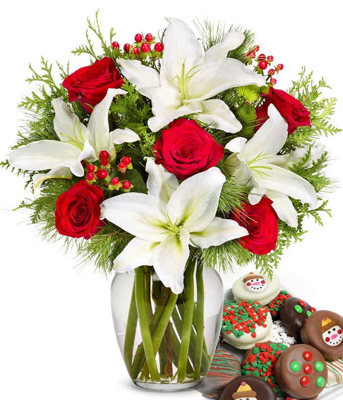 Bouquet of red roses, white lilies, red berries, and  seasonal greens, in a clear vase with one dozen chocolate dipped oreos with candy and snowman toppings