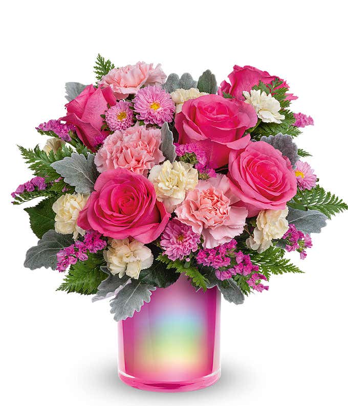 Pink roses and carnations arranged in a holographic cylinder vase