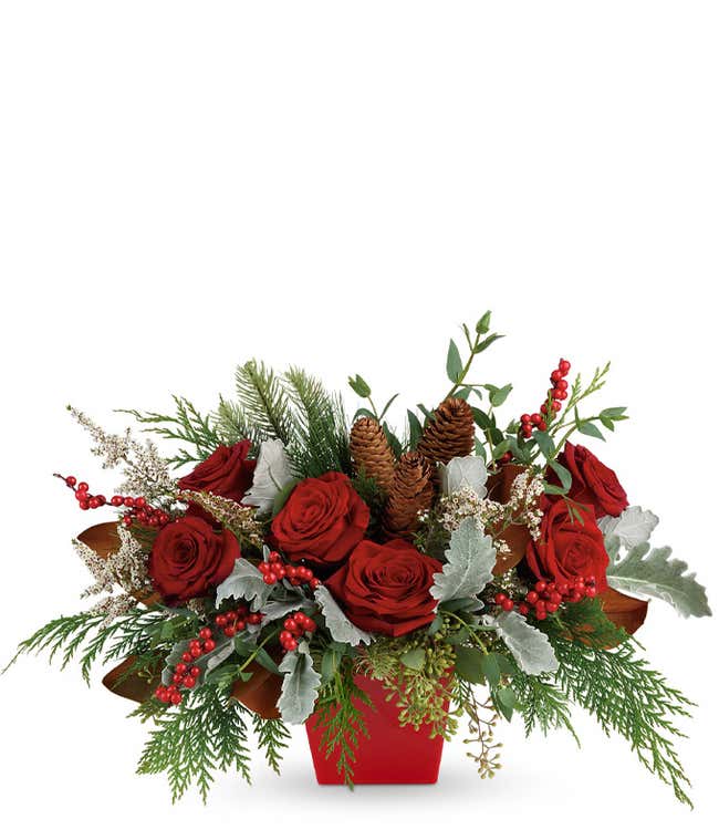 Red roses, pine cones and red hypericum berries christmas bouquet