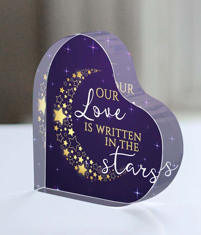 Purple acrylic heart with gold and white text saying Our Love was Written in the Stars, with a crescent moon made out of hearts